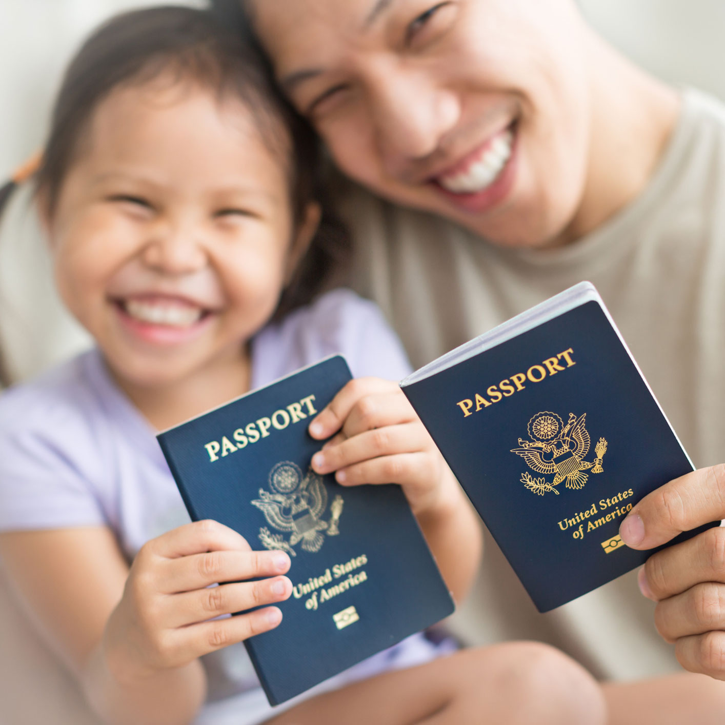 Father and daughter holding their U.S. passports