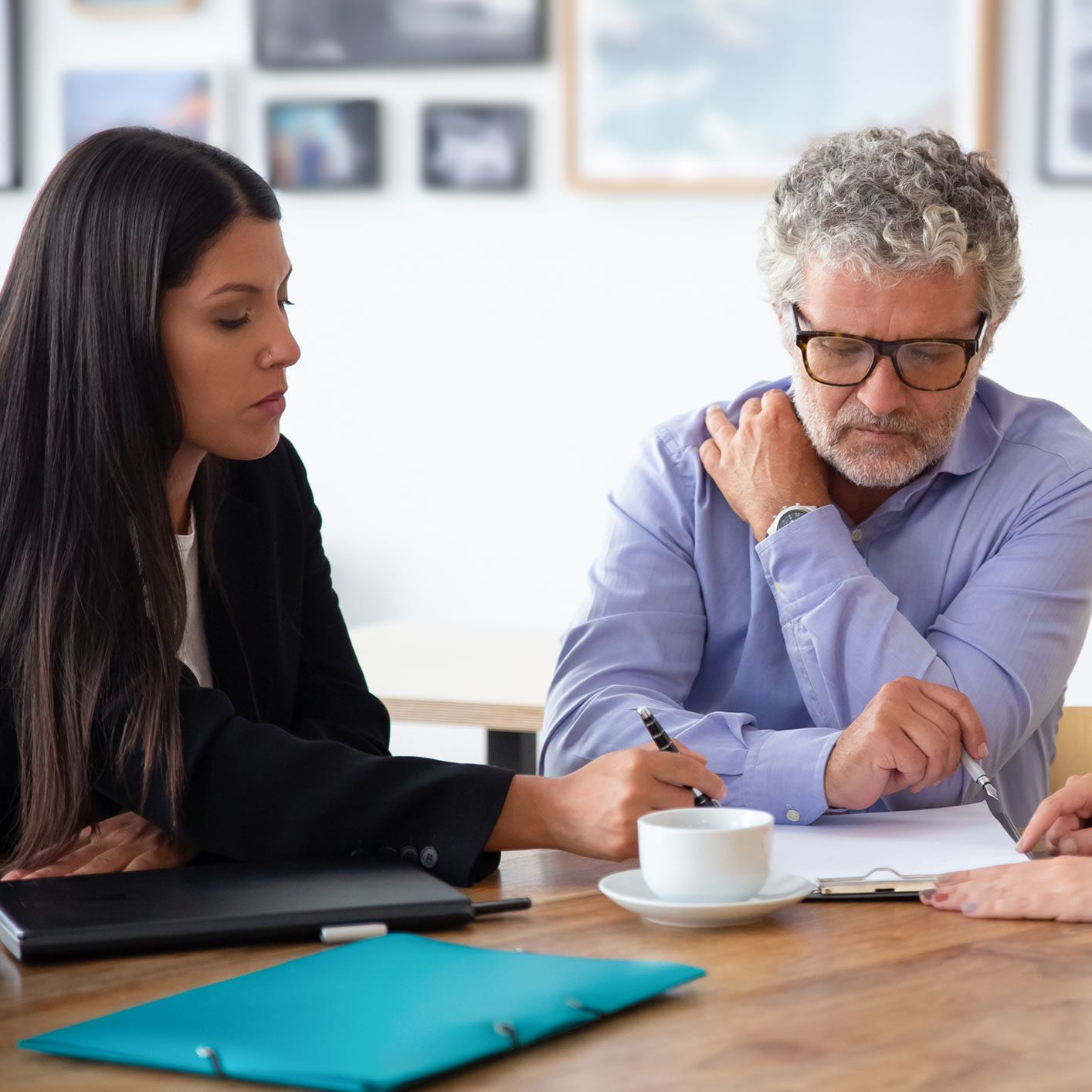 Lawyer consultation with client reviewing paperwork