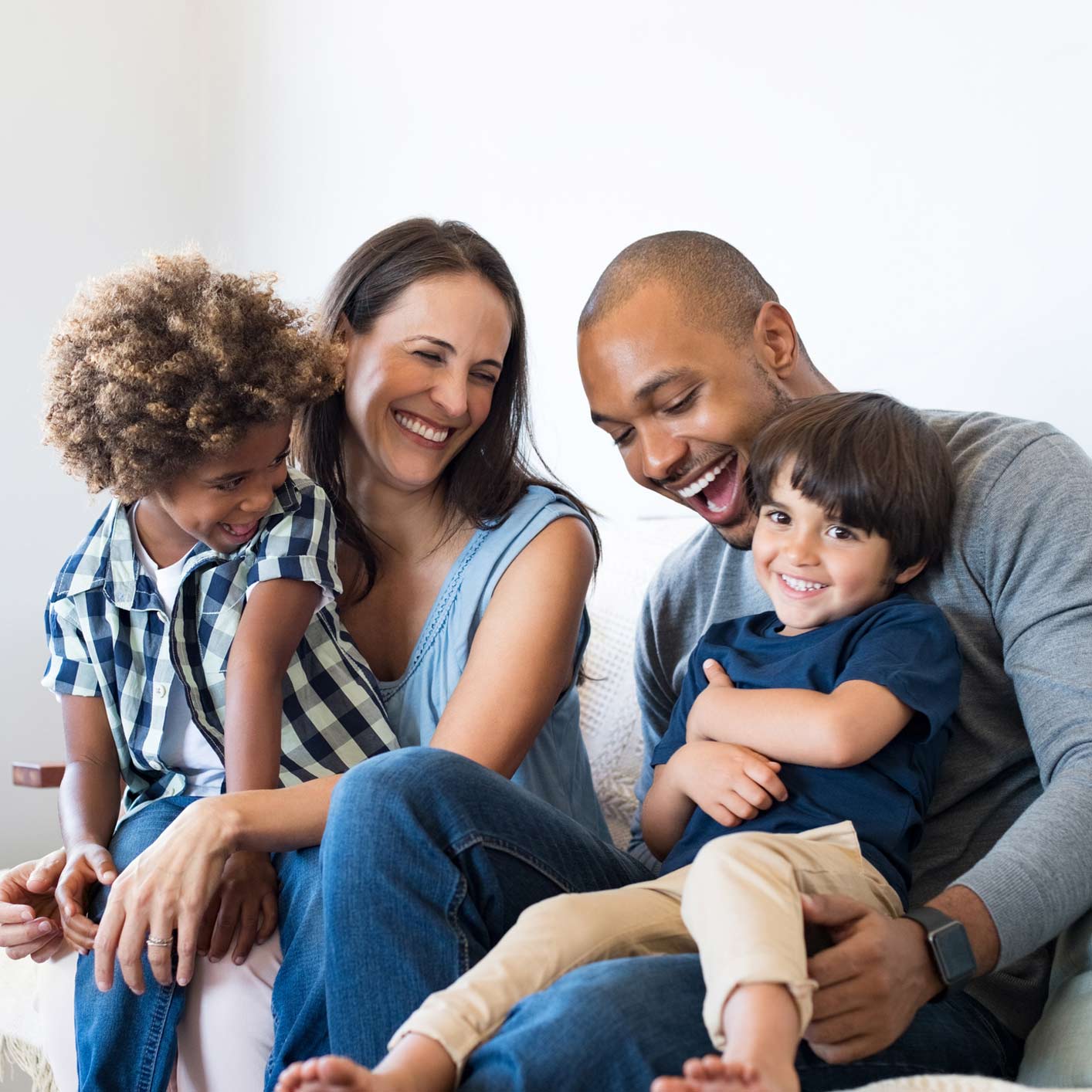 Interacial family sitting together on couch